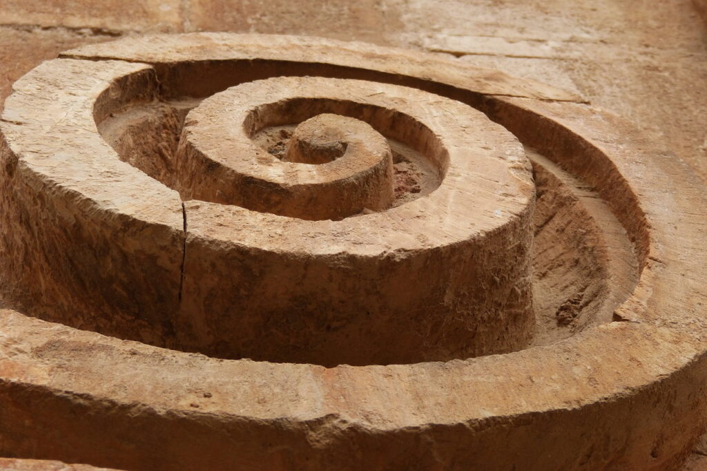 discerning resonance for health showing image with fibonacci spiral in carved stone symbolizing the inner journey